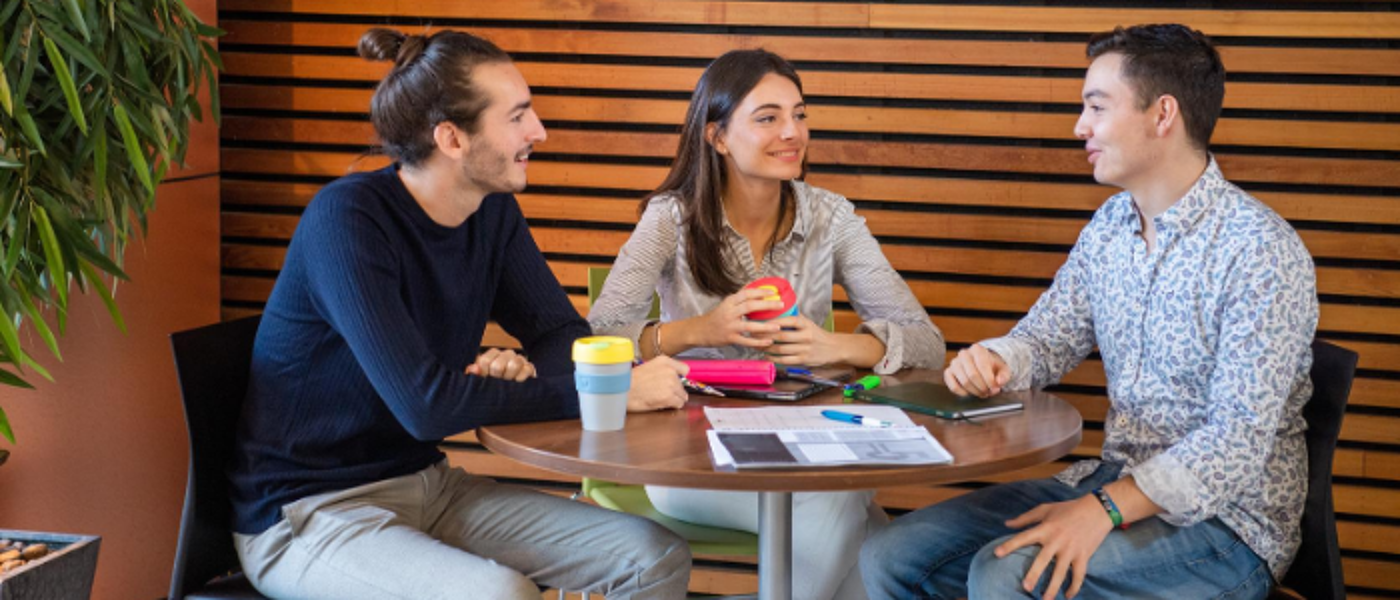 Three students at a table in the library
