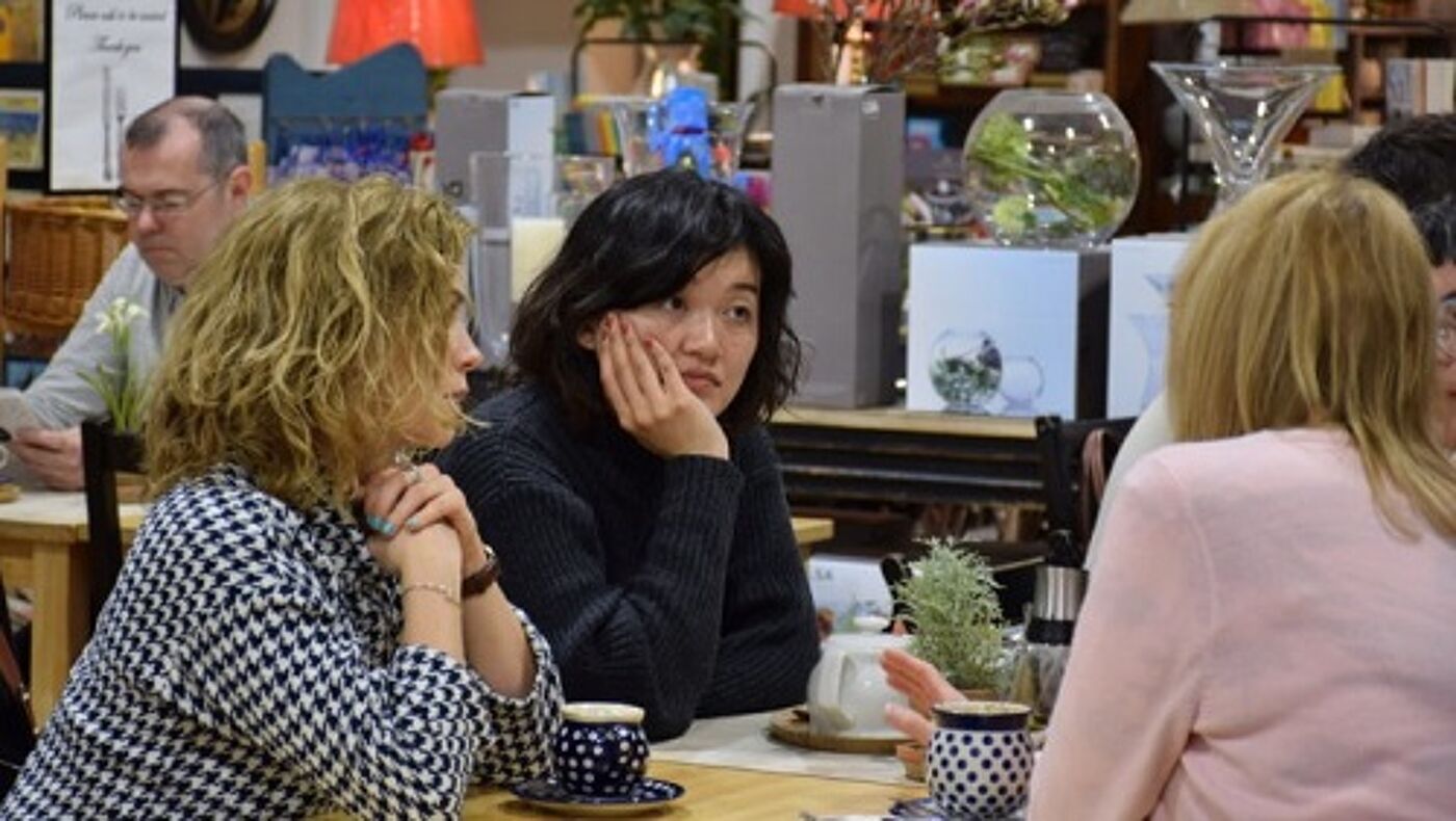 Women sitting around a table in a cafe