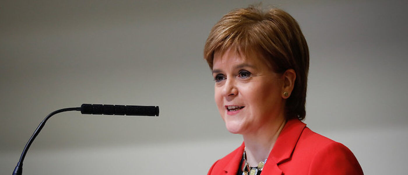 First Minister talking into microphone