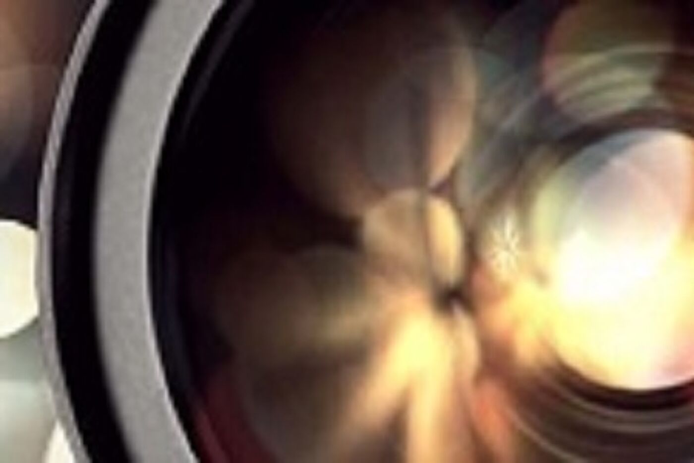 Close up of a camera lens with light reflections