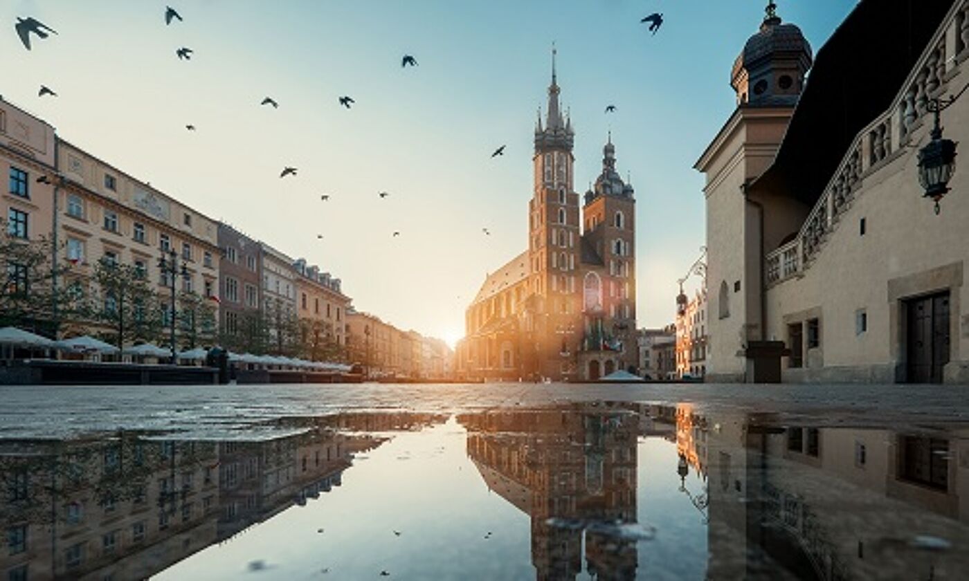 Eastern European square with spires, puddles and birds