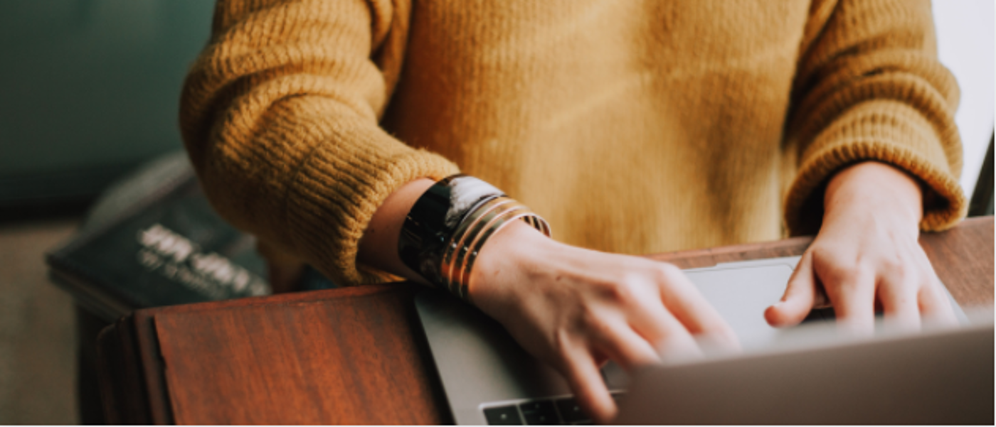 Image of someone typing on a laptop