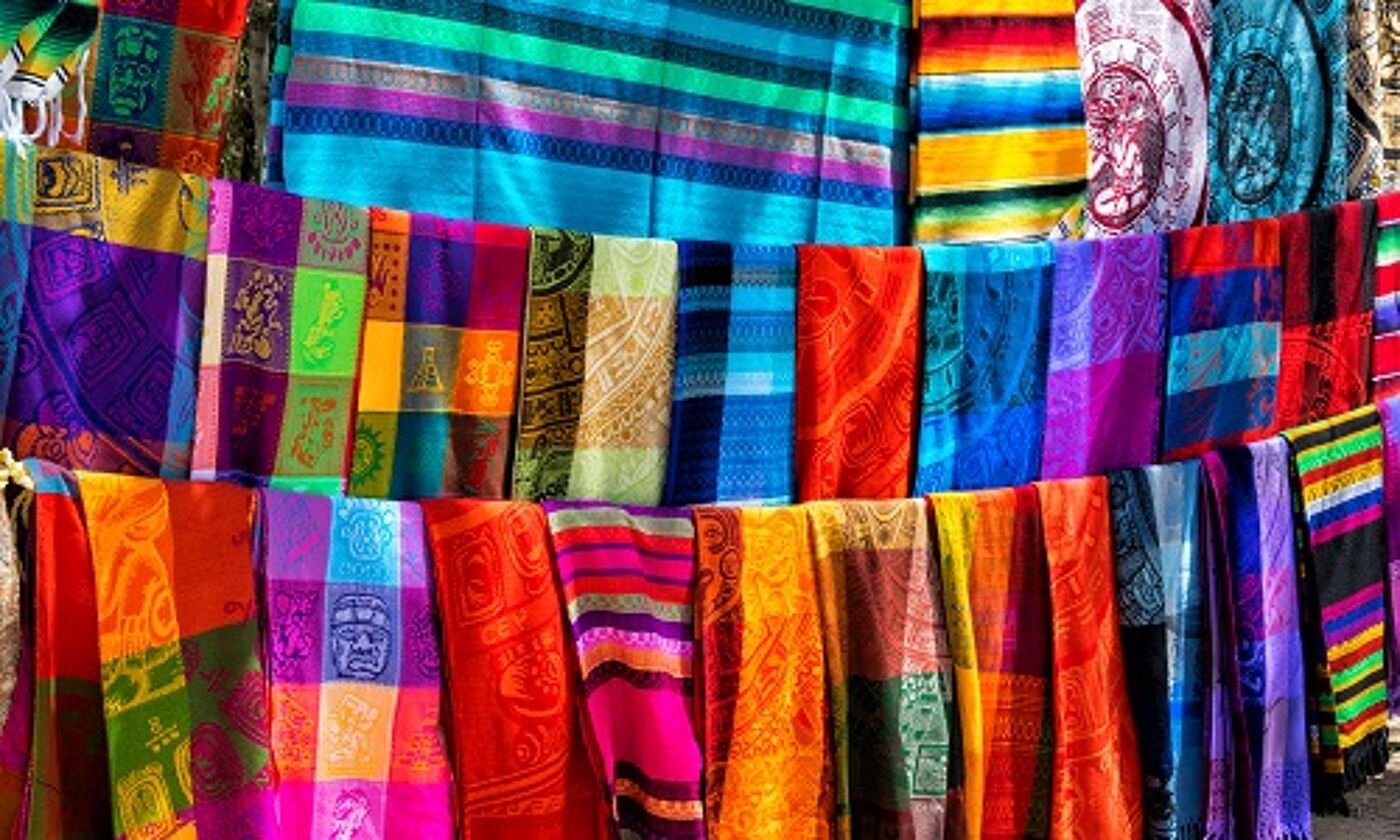 Multicoloured fabrics hanging, representing Latin America