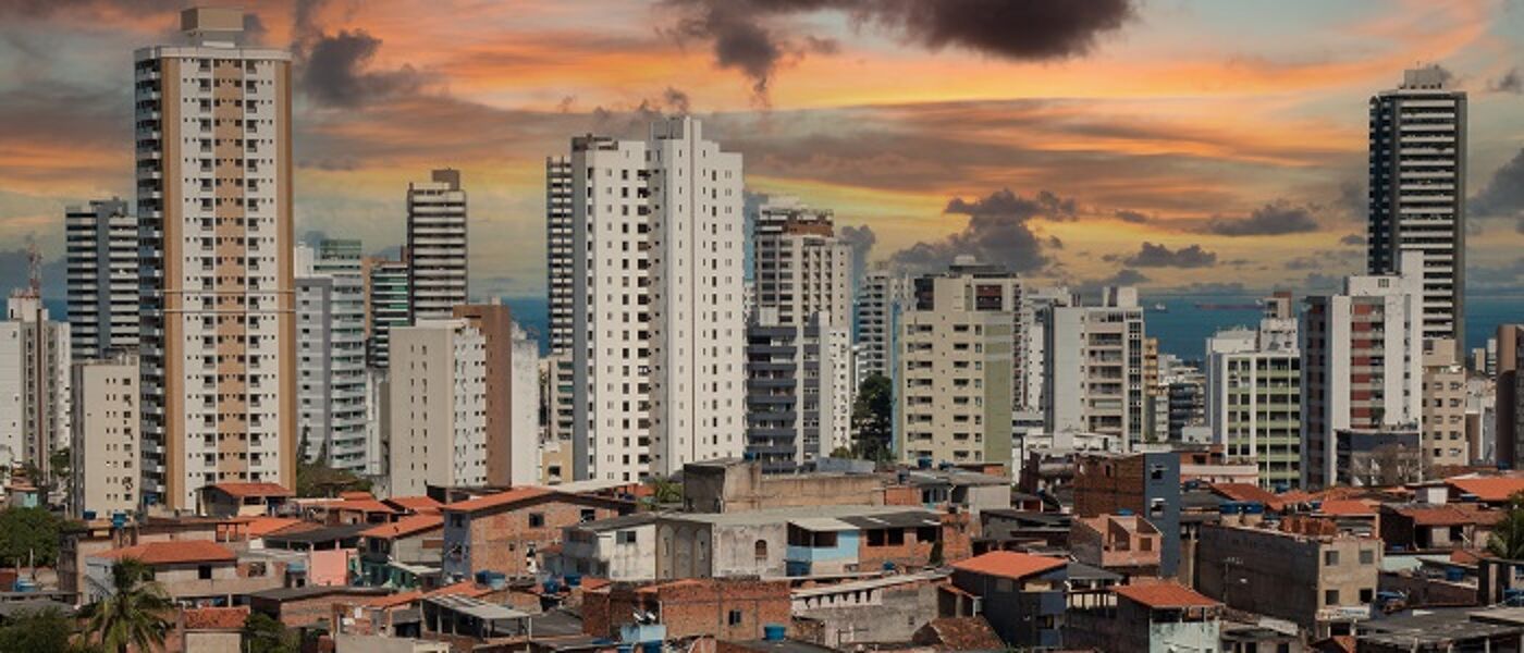 Landscape of high rise building with shanty town roofs in foreground
