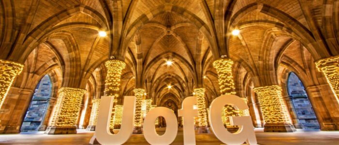 The University Cloisters with fairy lights around the pillars and large UofG letters on display