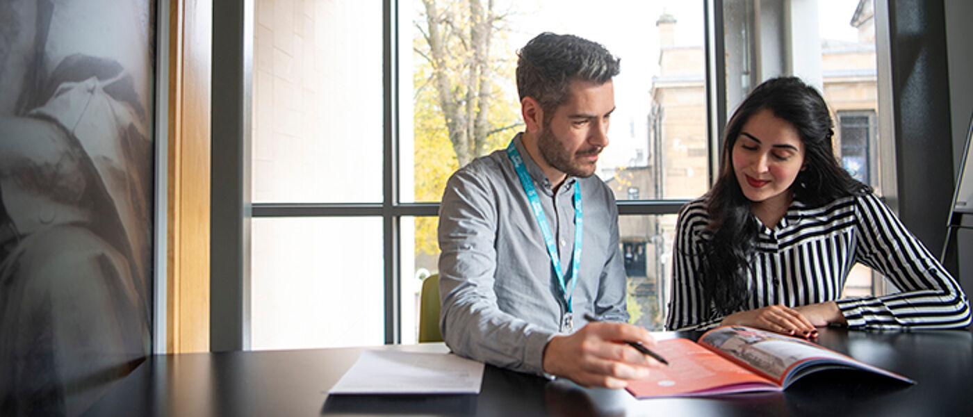 Student meeting with a member of staff in the Fraser Building