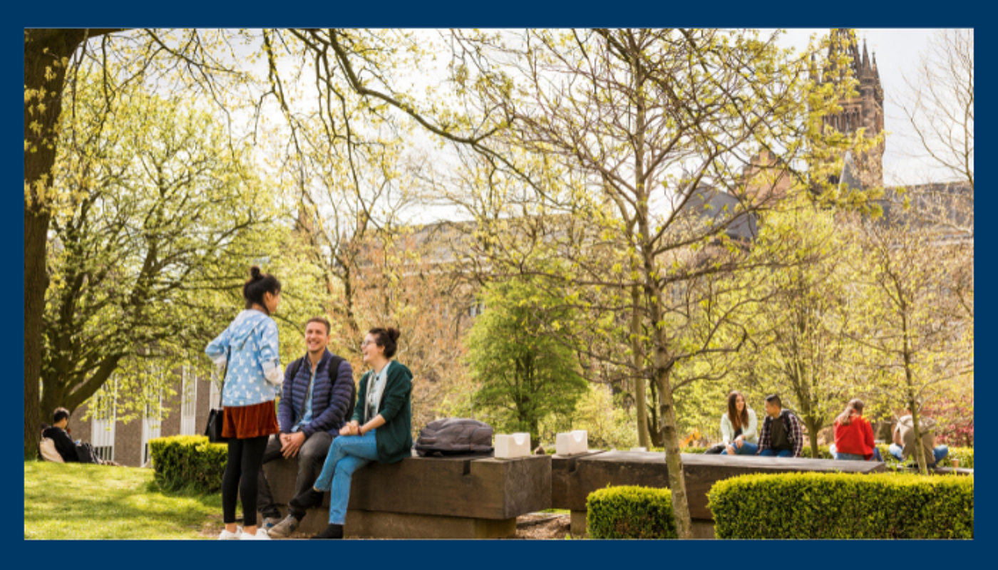 Outside the Fraser Building students sit and chat.  Image chosen to depict the linkage of outdoors and social with wellbeing