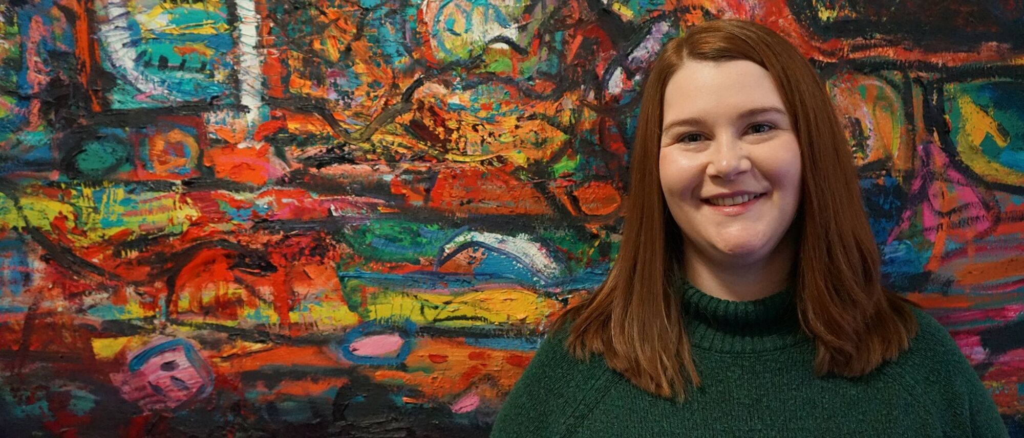 Student standing in front of artwork - Dumfries