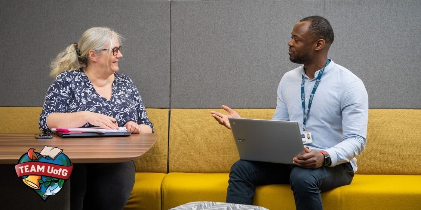 two people sitting around a table having a discussion
