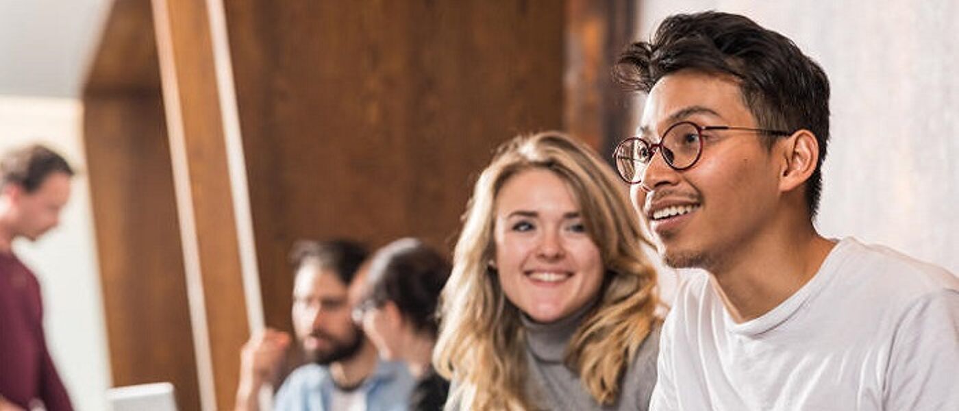 Two students chatting in a cafe. A woman smiles as a man talks. Source: Glasgow University Image Library