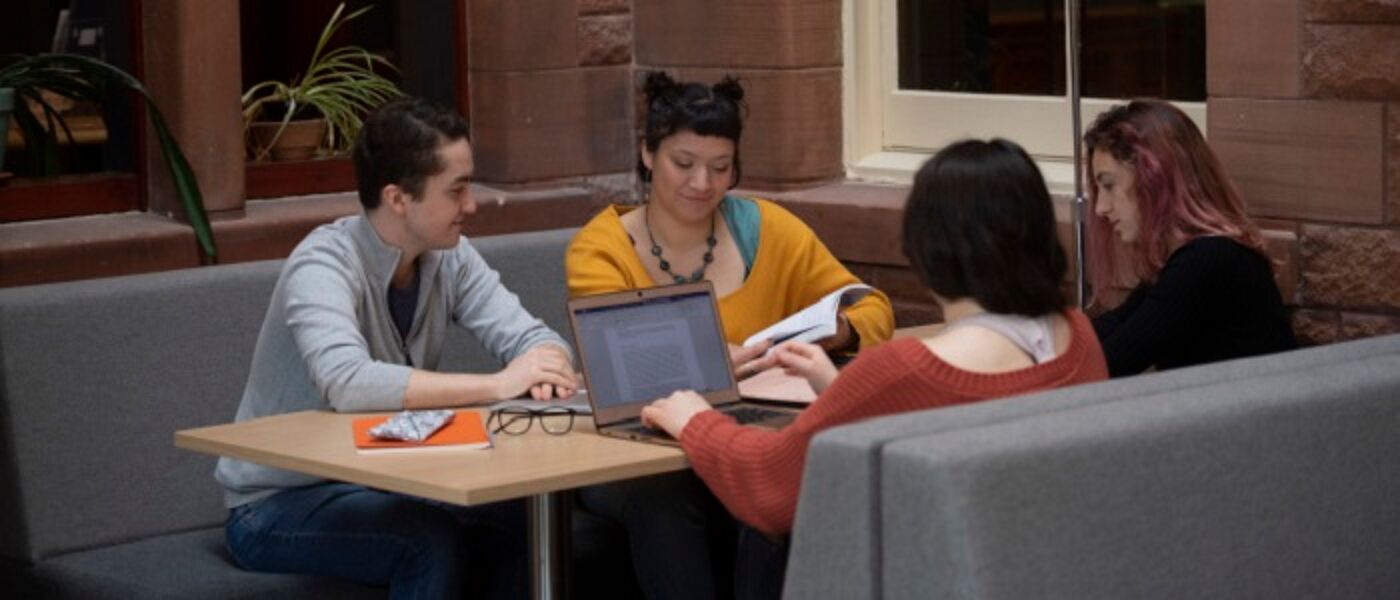 Four people studying around a table with papers, notes and laptops. Source: GU Image Library
