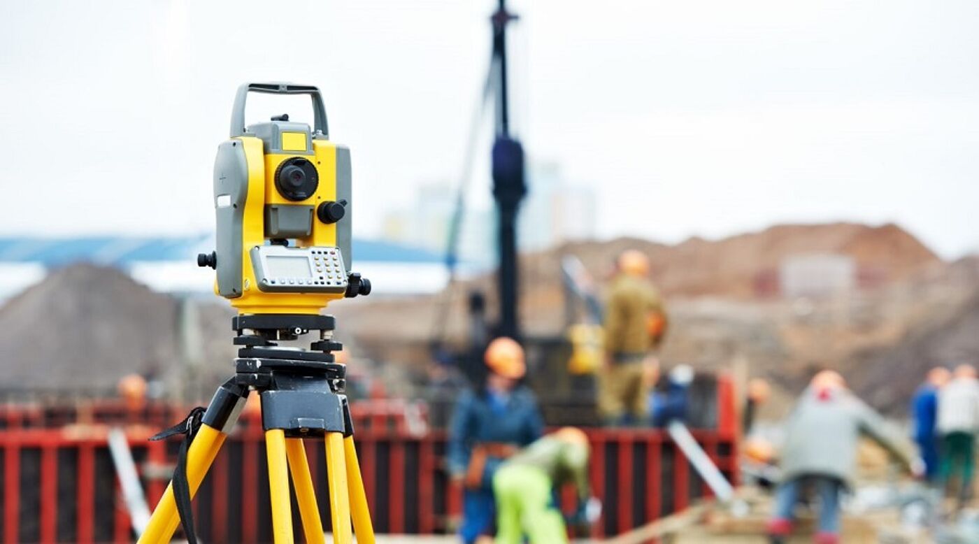Surveying equipment on tripod at construction site