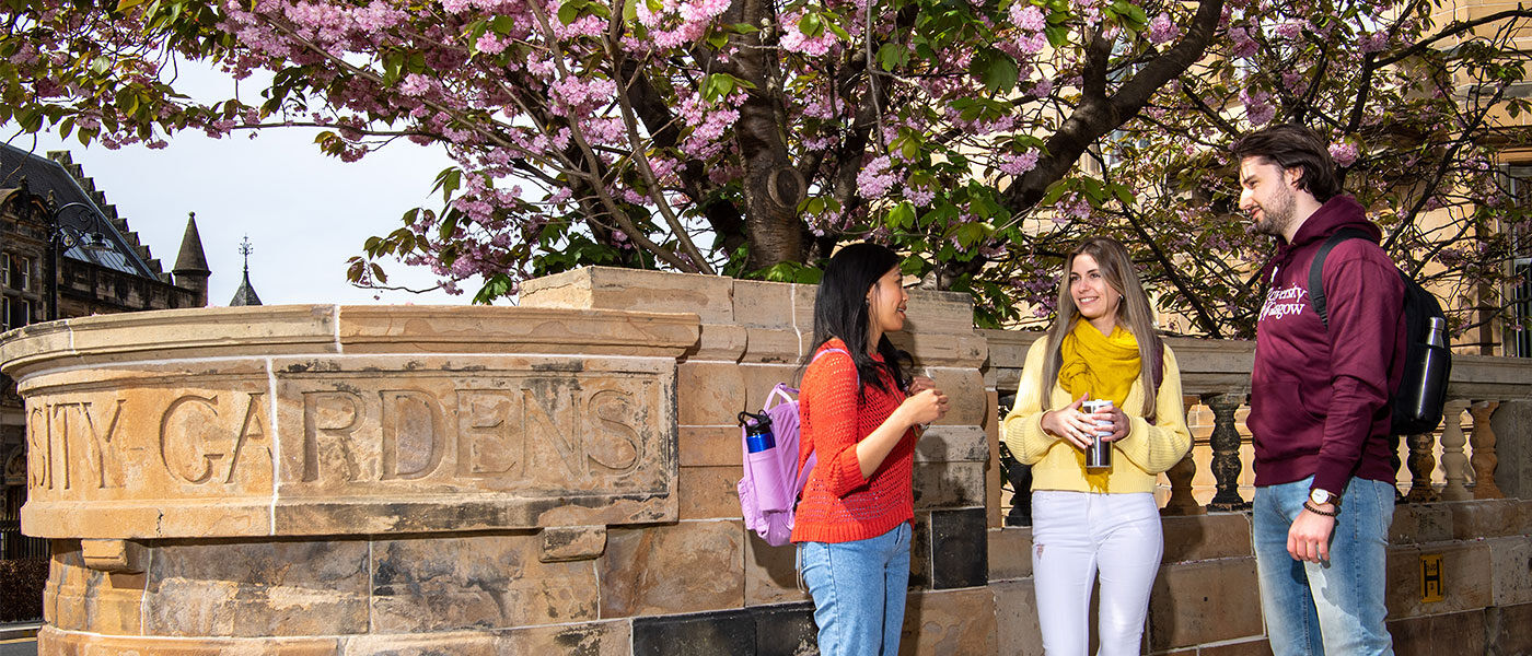 Three students chatting on University Avenue