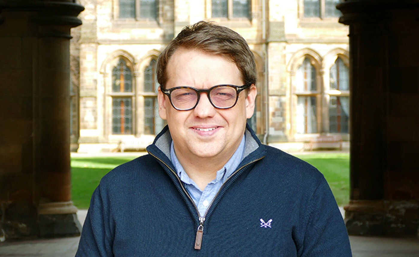 Dr Anthony Devine profile photo in the west quad of the University of Glasgow