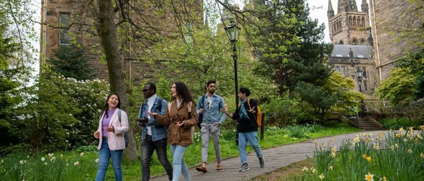 Students on Professors' Walk beside the Gilbert Scott Building