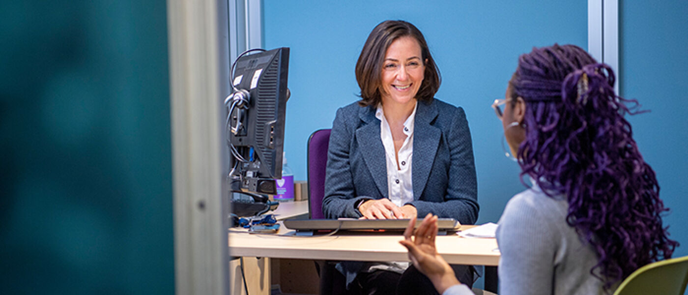 Student speaking with a staff member