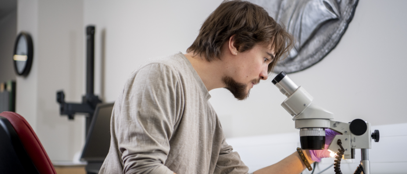 Man looking through a microscope