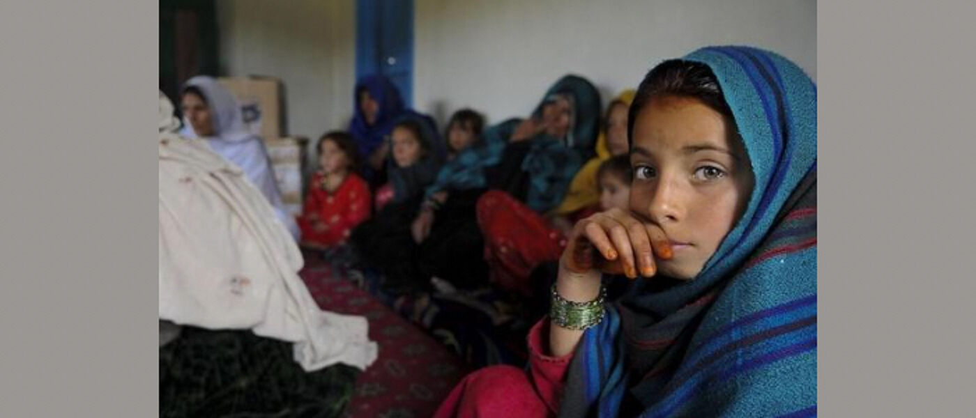 A group of Afghan girls and women wearing head scarves 