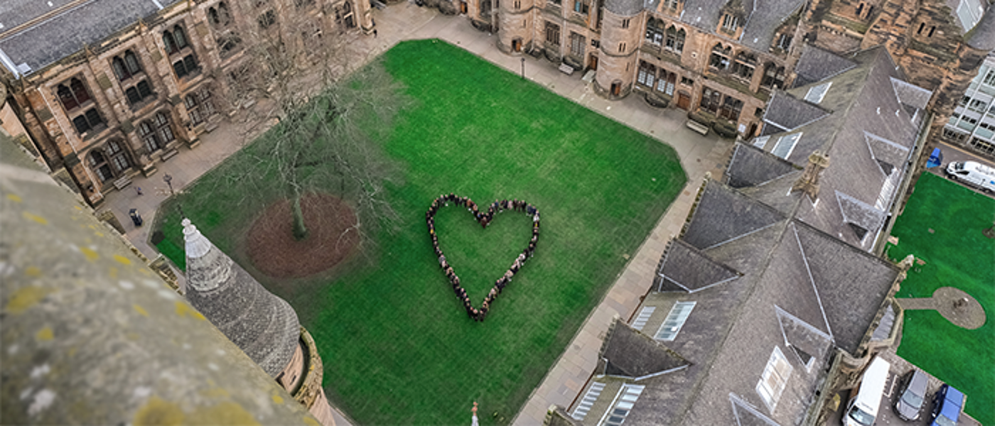 UofG staff and students forming a heart in the quadrangle