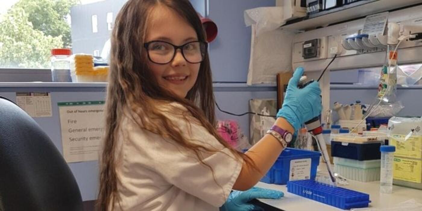 Young child learning to use pipette in the Cardiovascular laboratory