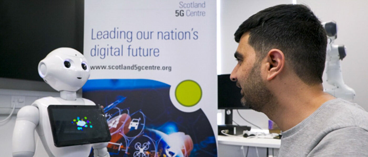 A researcher looking at a 5G enabled robot