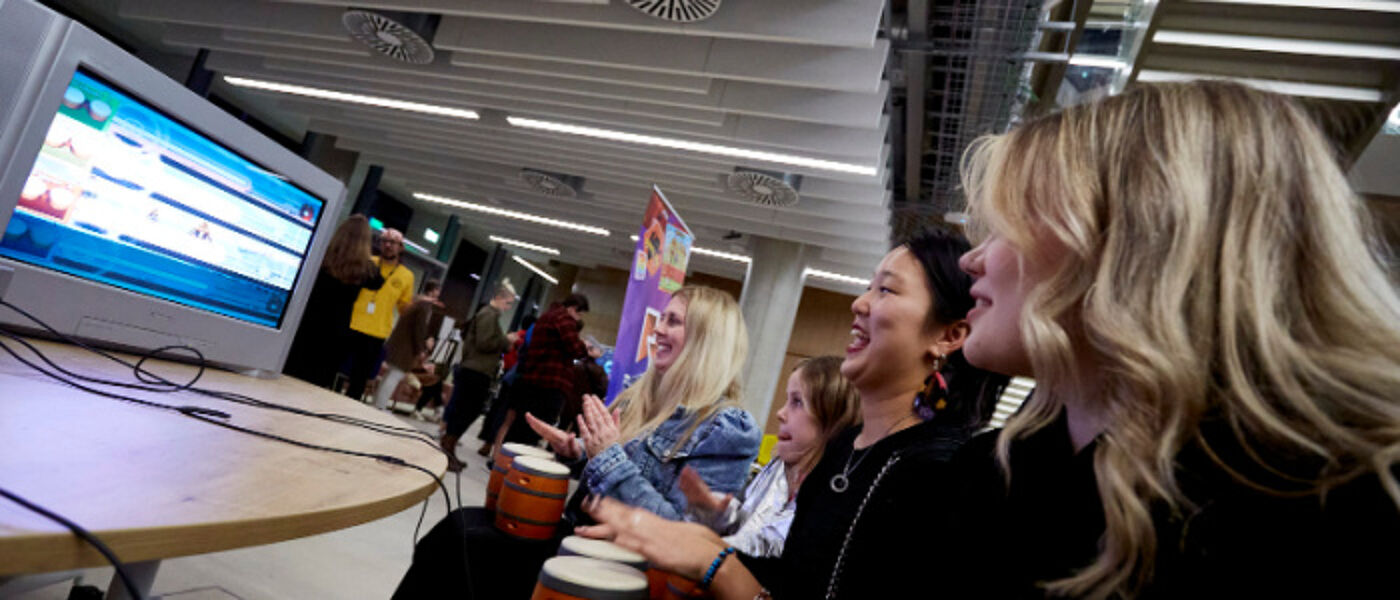 Visitors use a computer at ARCADIA festival of ideas in the ARC