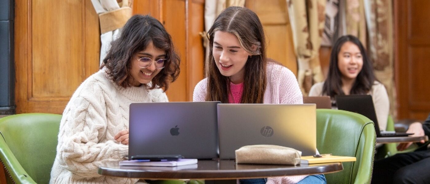 Students in the Glasgow University Union looking at their laptops
